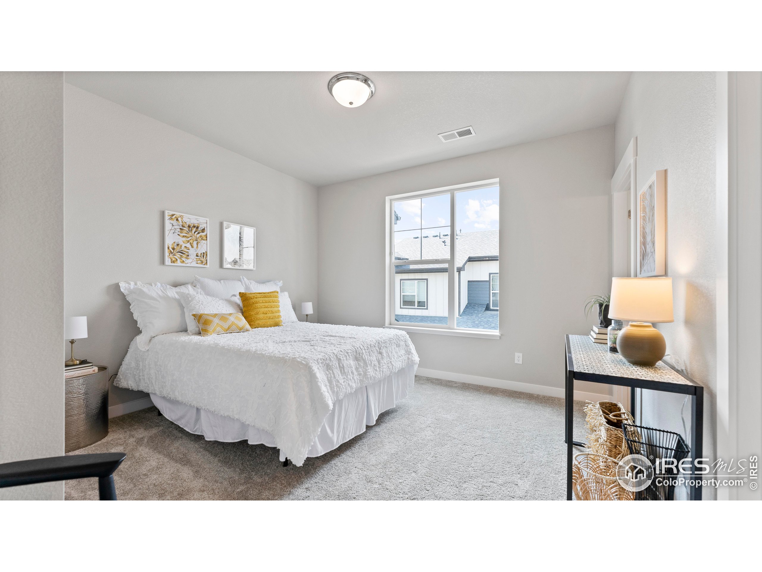 6780 Maple Leaf Drive Timnath, CO 80547 - Photo 22 of 26 a living room with a bed furniture and next to a window