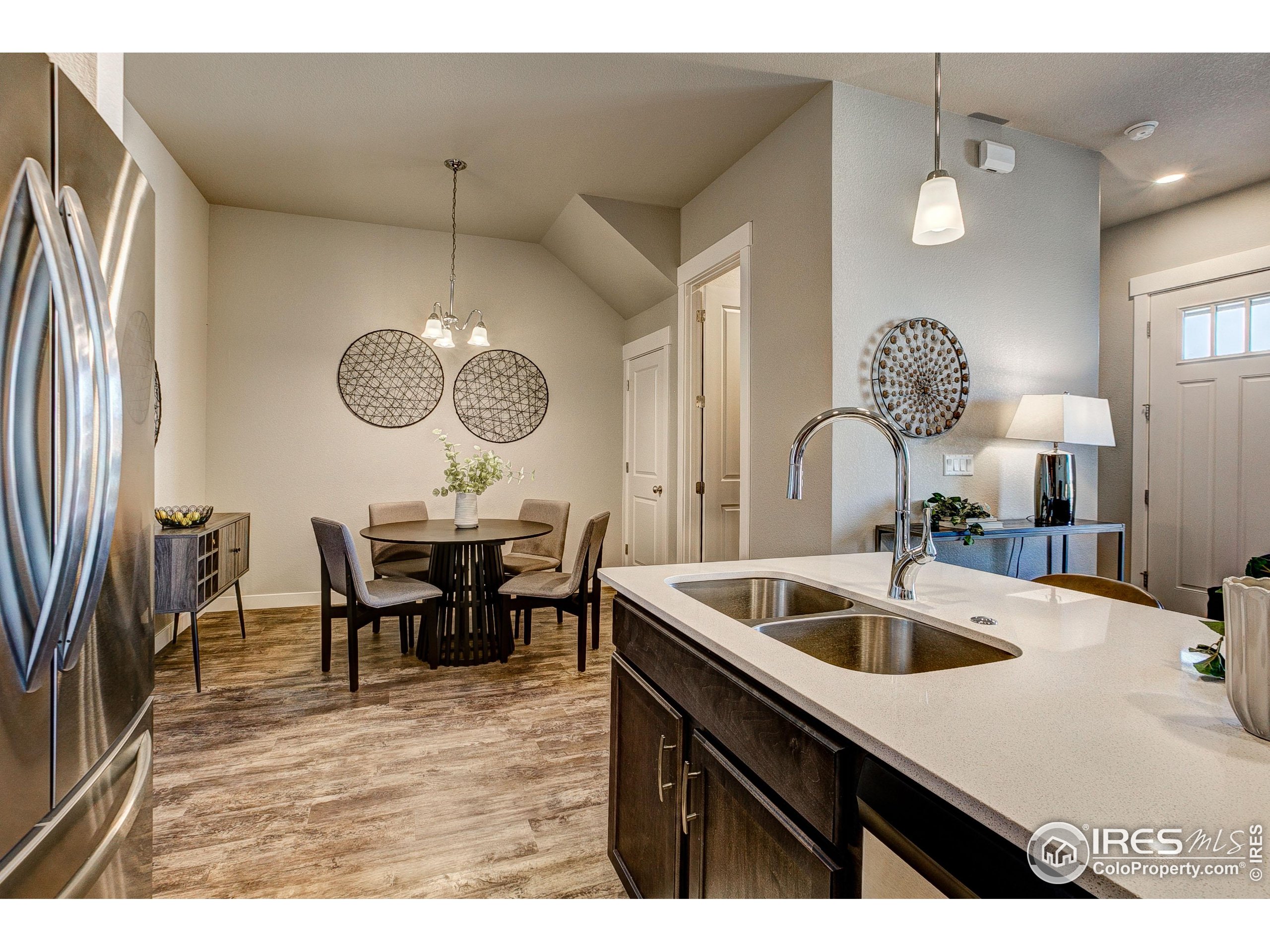 6780 Maple Leaf Drive Timnath, CO 80547 - Photo 5 of 26 a kitchen with a table chairs and a sink