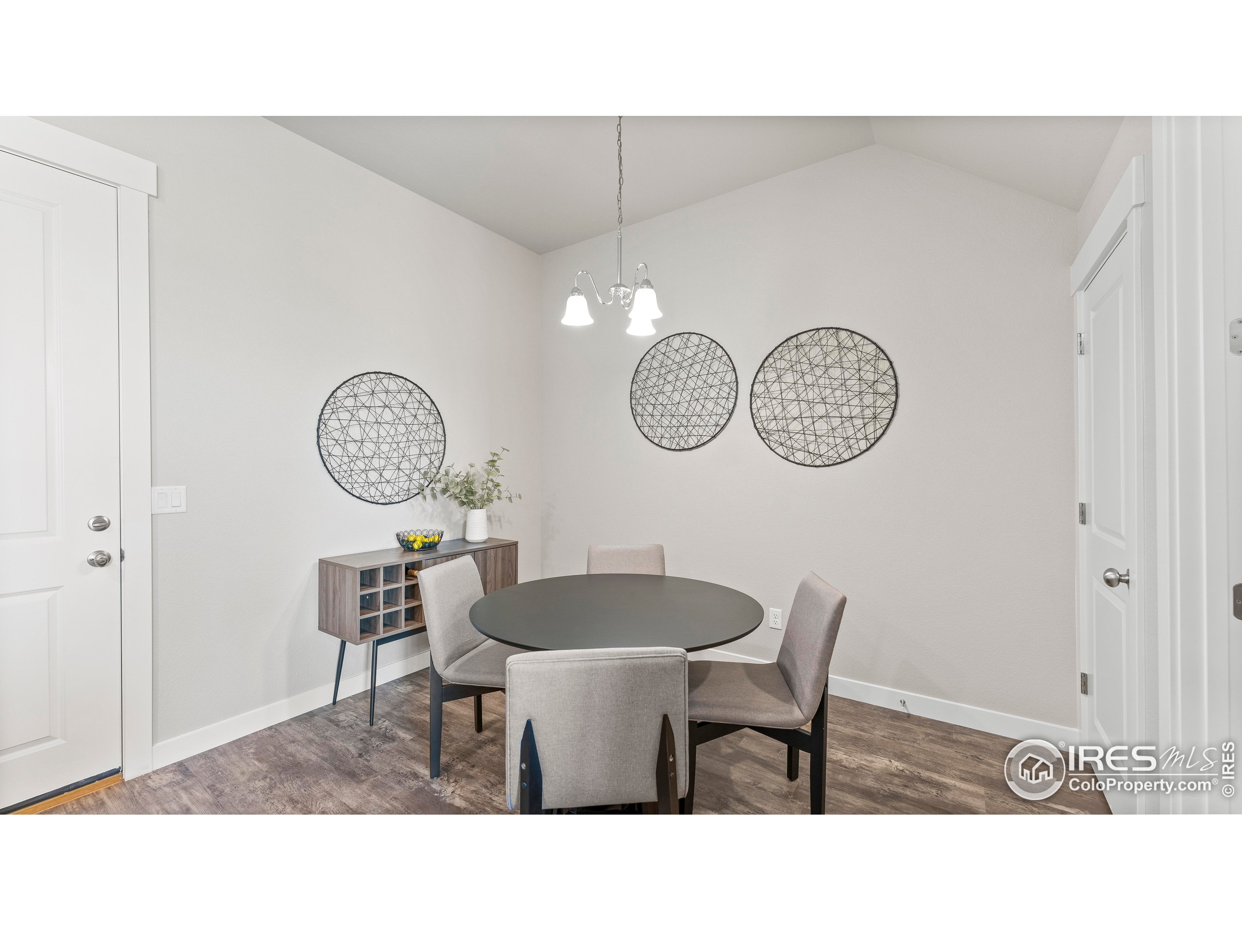 6780 Maple Leaf Drive Timnath, CO 80547 - Photo 7 of 26 a kitchen with a dining table and a clock