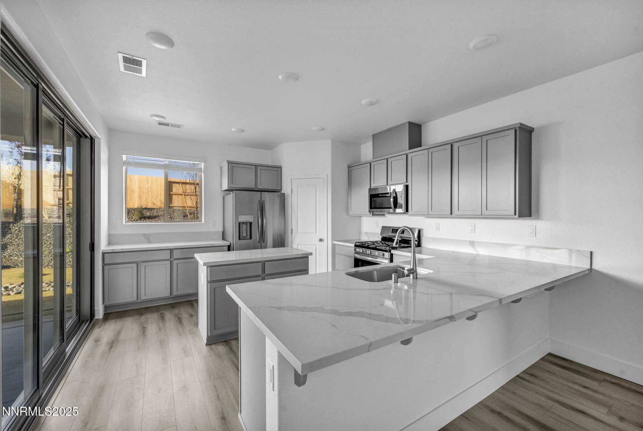 1328 Nebula Road, Unit HOMESITE 93 Carson City, NV 89705 - Photo 2 of 12 a kitchen with a sink stove and refrigerator