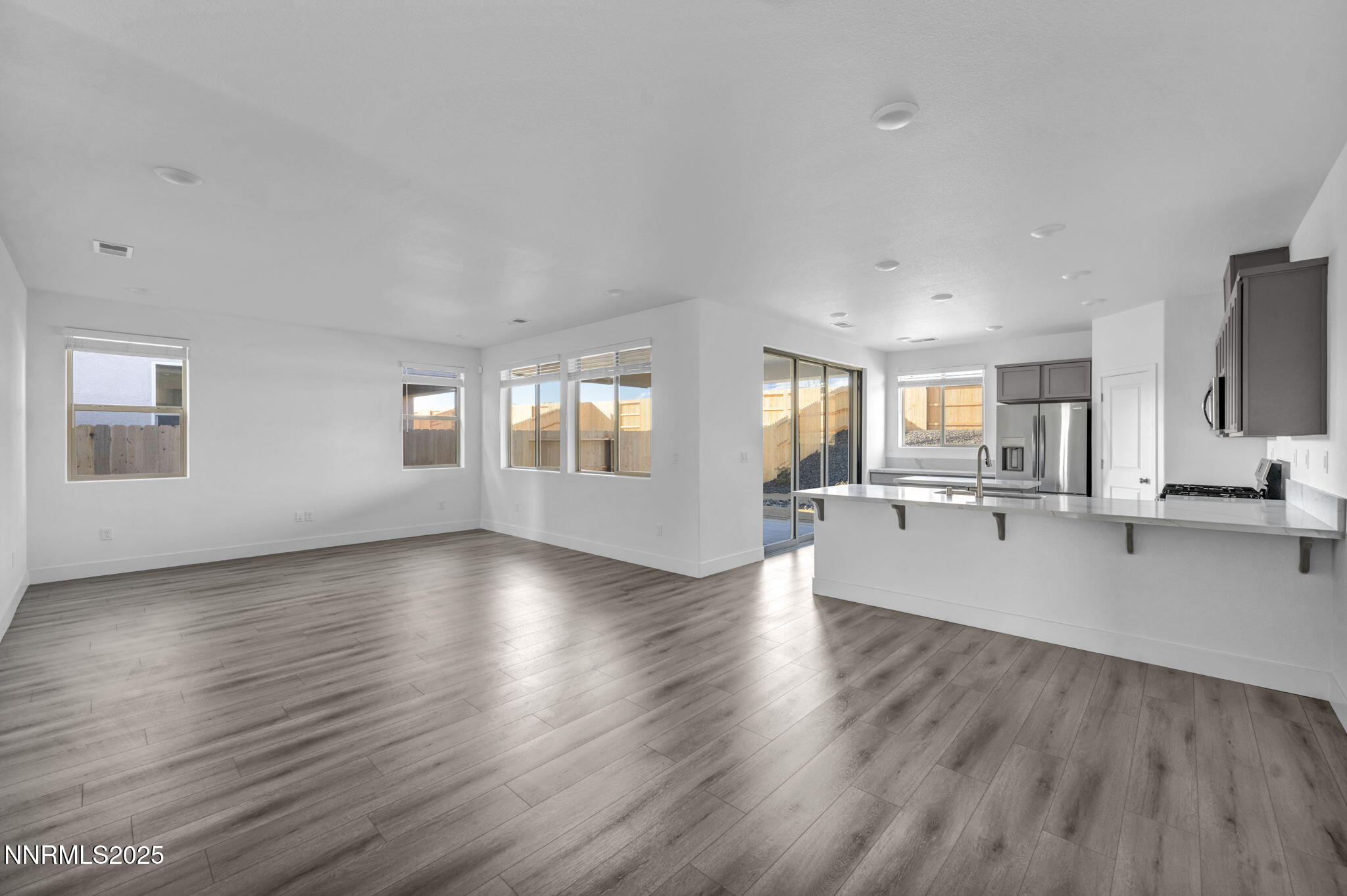 1328 Nebula Road, Unit HOMESITE 93 Carson City, NV 89705 - Photo 3 of 12 a view of a big room with wooden floor and windows