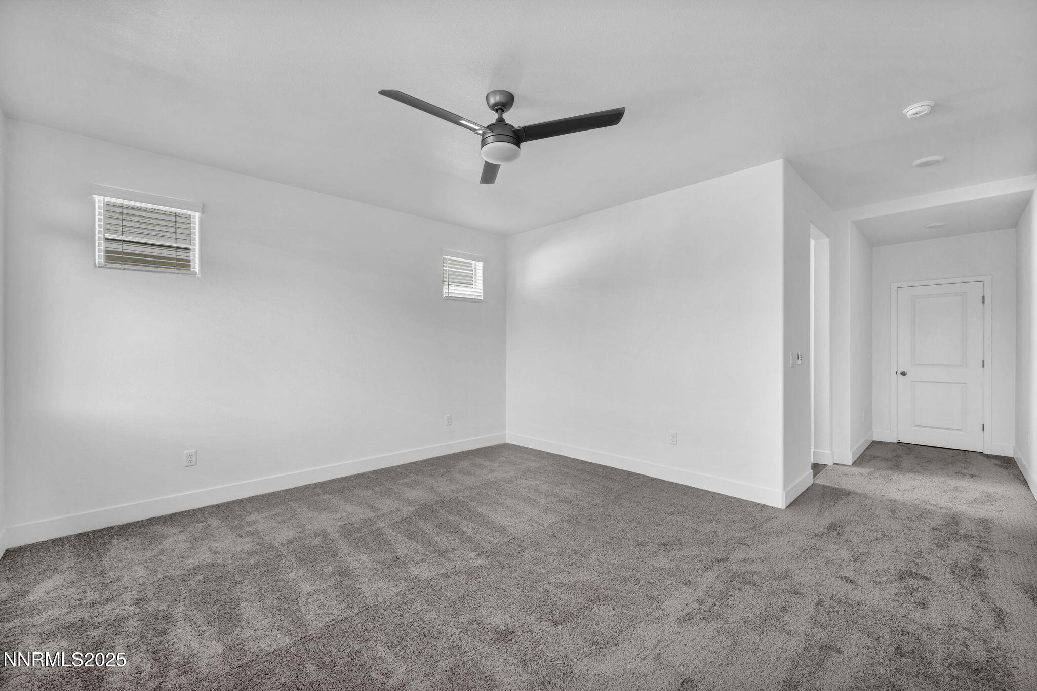 1328 Nebula Road, Unit HOMESITE 93 Carson City, NV 89705 - Photo 4 of 12 an empty room with a ceiling fan and a window