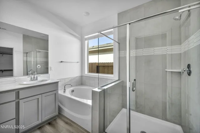 a bathroom with a granite countertop sink mirror and bathtub
