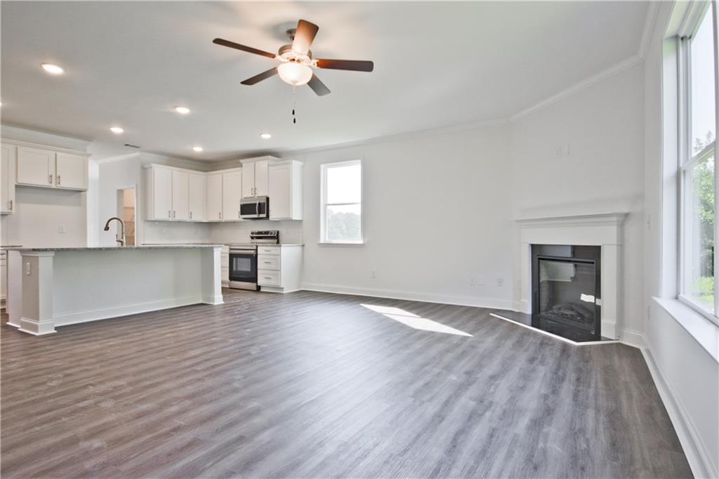 5985 Spring Way Lithonia, GA 30058 - Photo 11 of 34 a view of a kitchen with a fridge wooden floor and a window