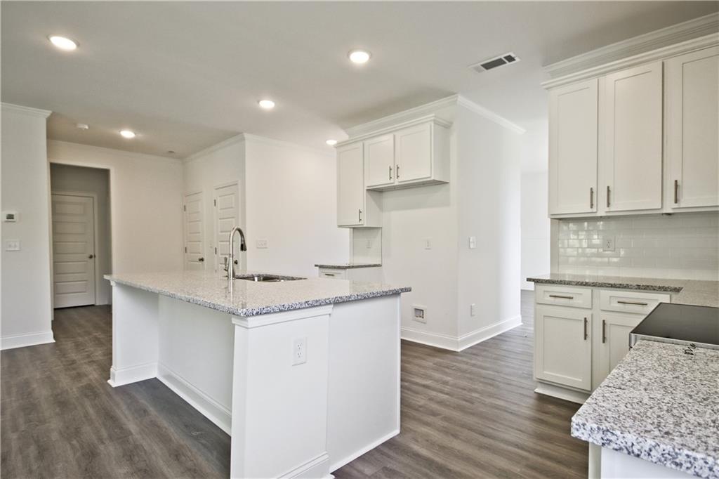 5985 Spring Way Lithonia, GA 30058 - Photo 13 of 34 a kitchen with a sink a stove a refrigerator and white cabinets