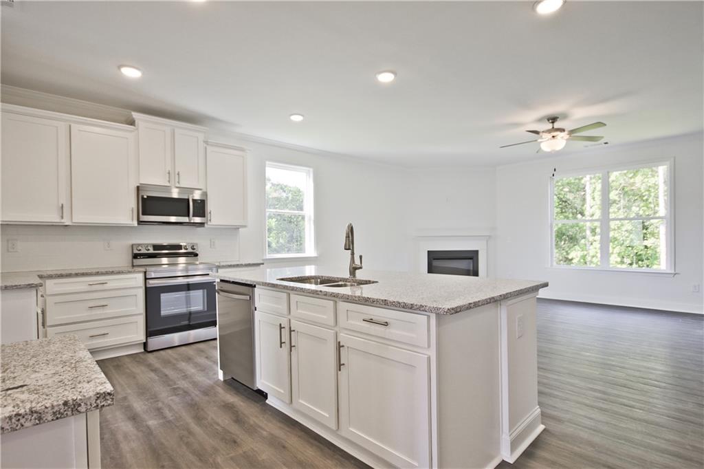 5985 Spring Way Lithonia, GA 30058 - Photo 15 of 34 a kitchen with granite countertop appliances cabinets and a sink