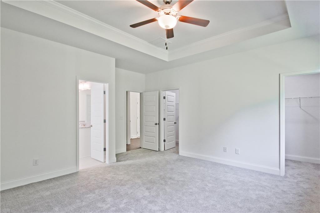 5985 Spring Way Lithonia, GA 30058 - Photo 18 of 34 an empty room with closet and a ceiling fan