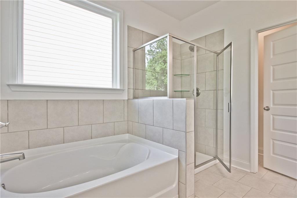 5985 Spring Way Lithonia, GA 30058 - Photo 21 of 34 a white bath tub sitting next to a window