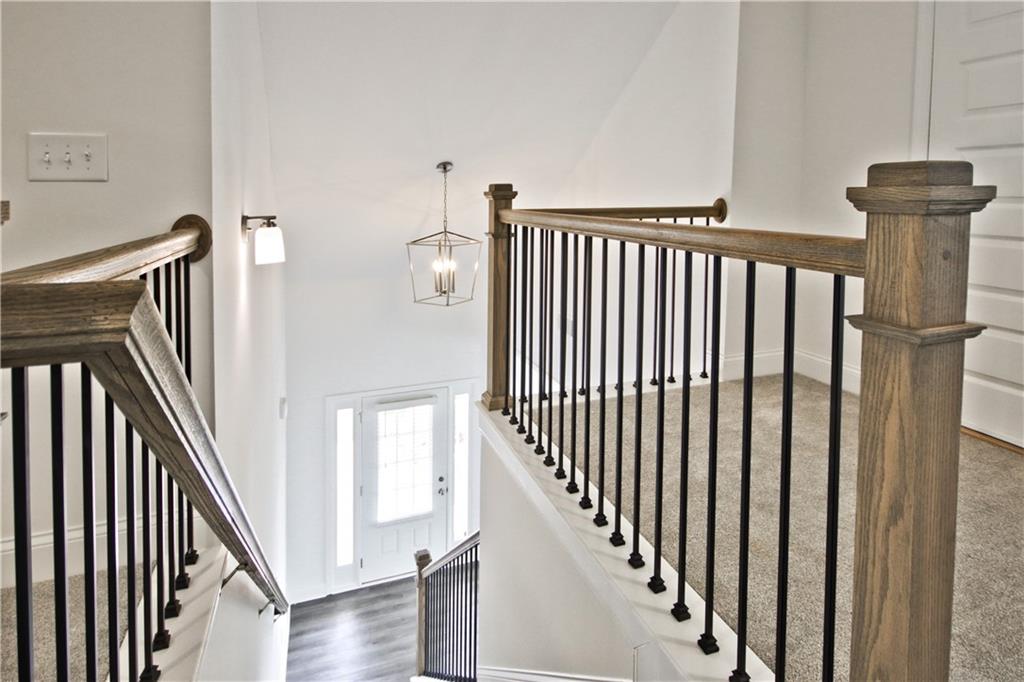 5985 Spring Way Lithonia, GA 30058 - Photo 28 of 34 a view of a hallway with wooden floor and staircase