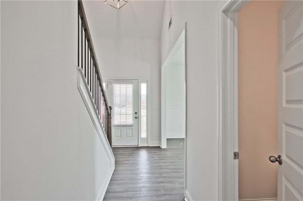 5985 Spring Way Lithonia, GA 30058 - Photo 4 of 34 a view of a hallway with wooden floor and staircase