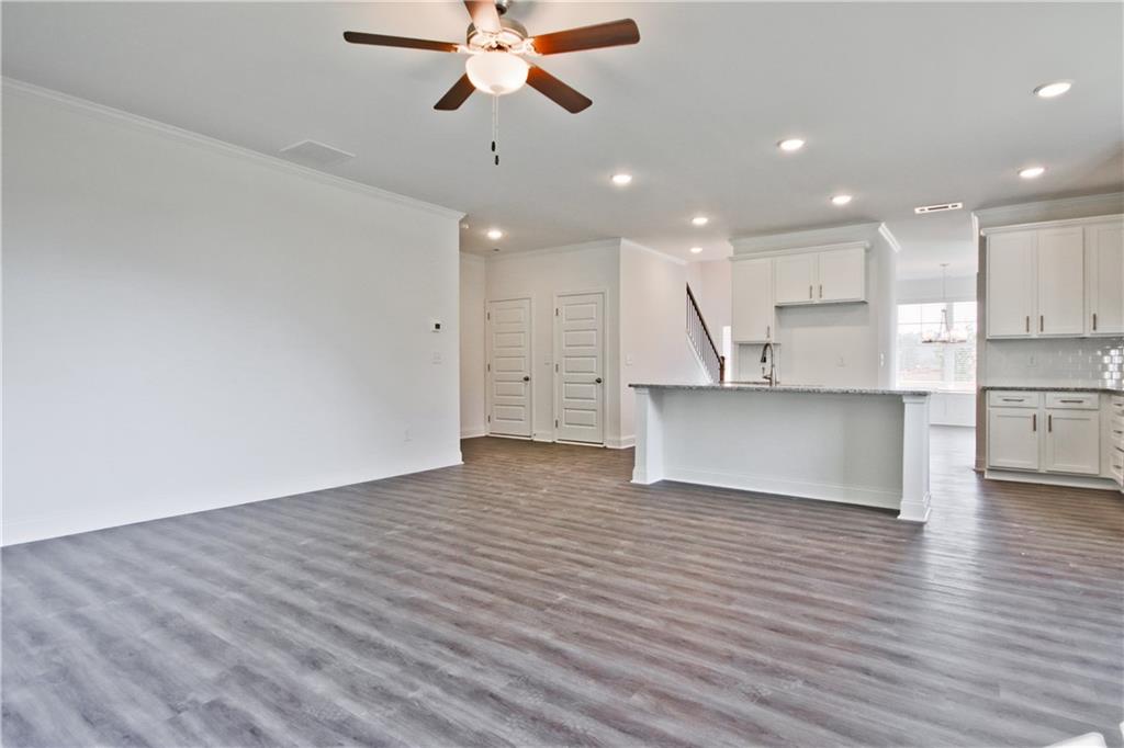 5985 Spring Way Lithonia, GA 30058 - Photo 10 of 34 an empty room with wooden floor and a ceiling fan