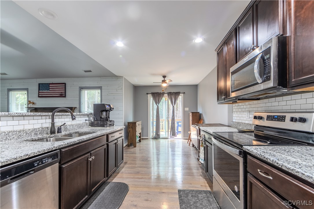 1990 Walnut Tree Road Powhatan, VA 23139 - Photo 11 of 40 a kitchen with stainless steel appliances granite countertop a sink stove and refrigerator