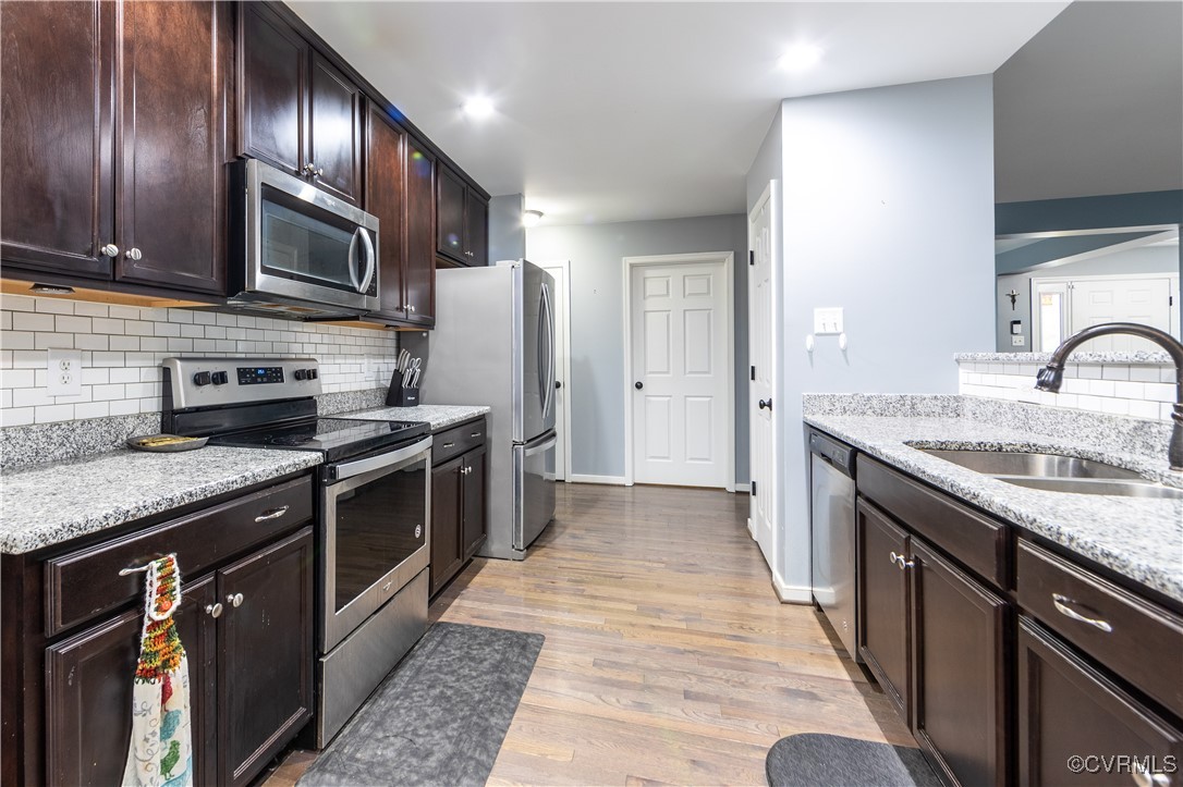 1990 Walnut Tree Road Powhatan, VA 23139 - Photo 12 of 40 a kitchen with stainless steel appliances granite countertop a sink stove oven and refrigerator