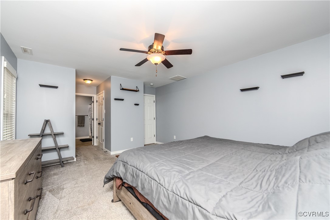 1990 Walnut Tree Road Powhatan, VA 23139 - Photo 16 of 40 a bedroom with a bed and a chandelier