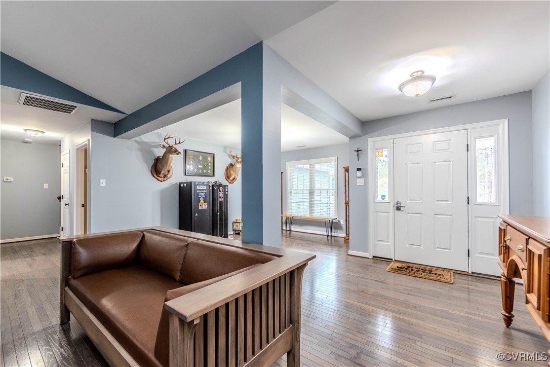 1990 Walnut Tree Road Powhatan, VA 23139 - Photo 6 of 40 a living room with a bed and wooden floor
