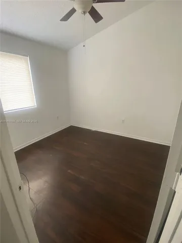 an empty room with a fan