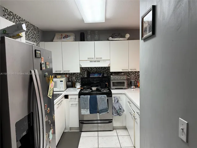 a kitchen with stainless steel appliances a refrigerator sink and cabinets