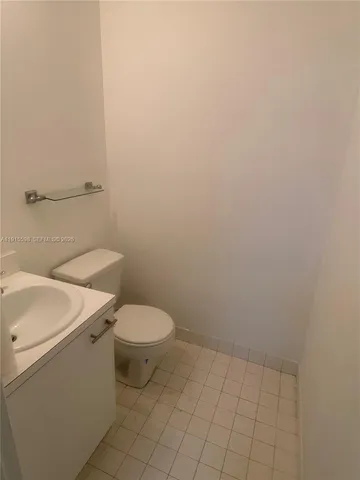 a white toilet sitting next to a white sink