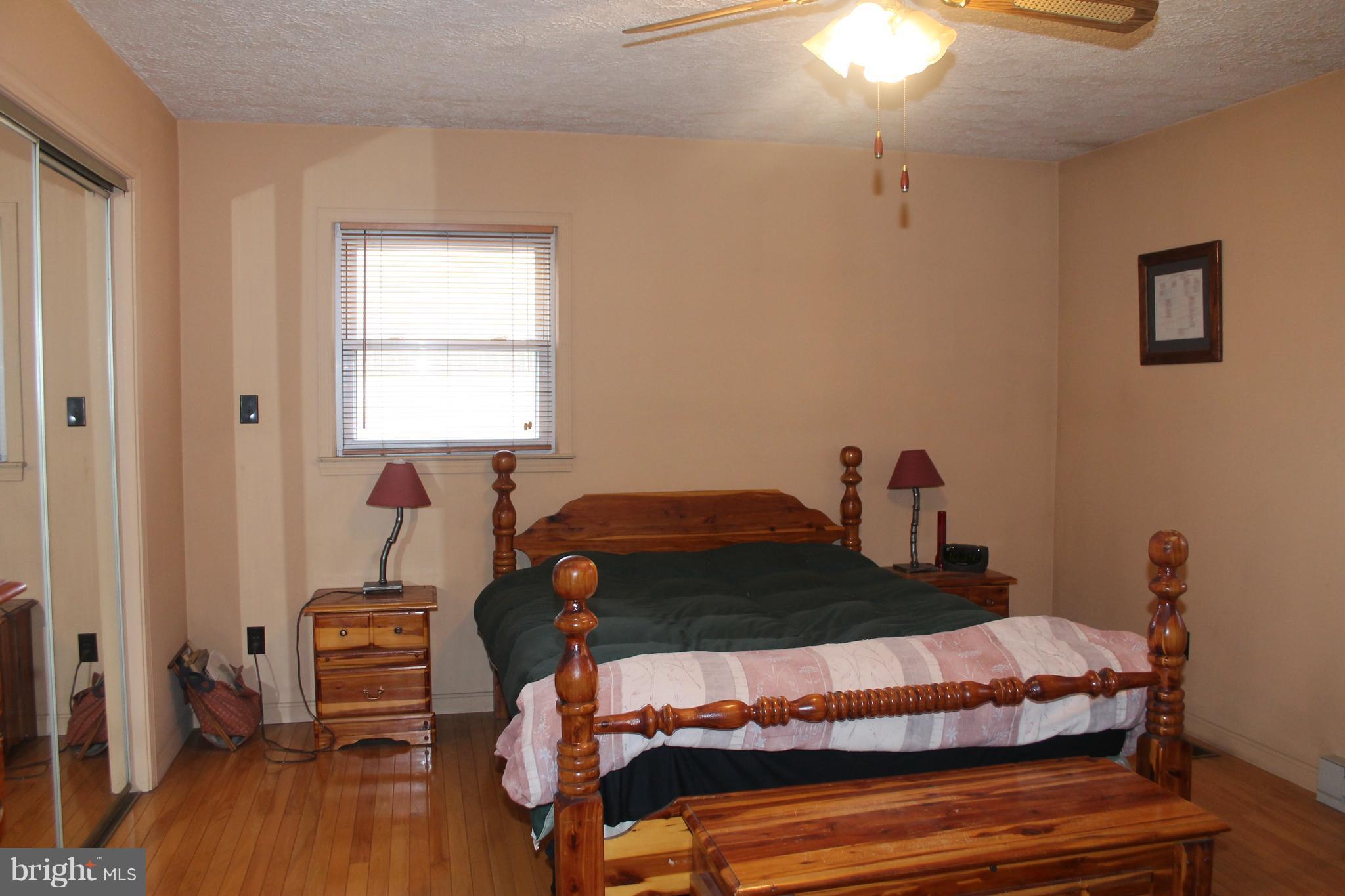64 Castle Mountain Road Castleton, VA 22716 - Photo 17 of 29 Master Bedroom, wood floor and ceiling fan