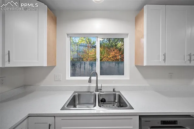 a kitchen with a sink and cabinets