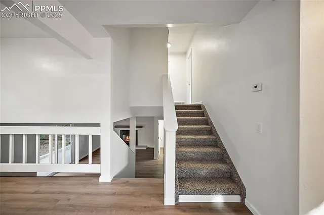 a view of entryway and hall with wooden floor