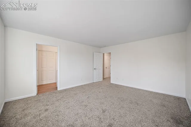 a view of an empty room and closet