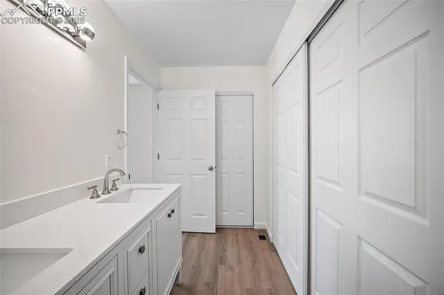 a bathroom with a double vanity sink and a mirror