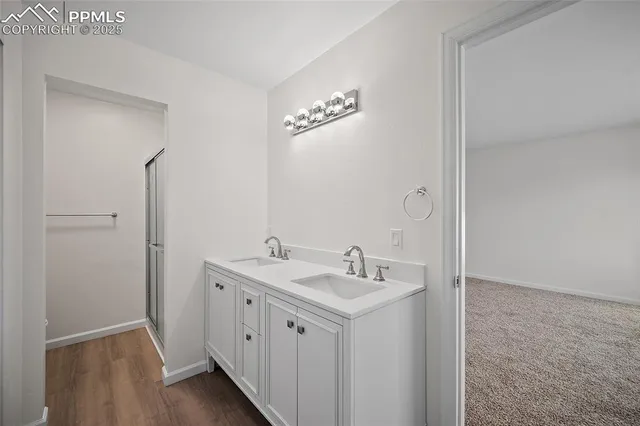 a spacious bathroom with a double vanity sink and a mirror