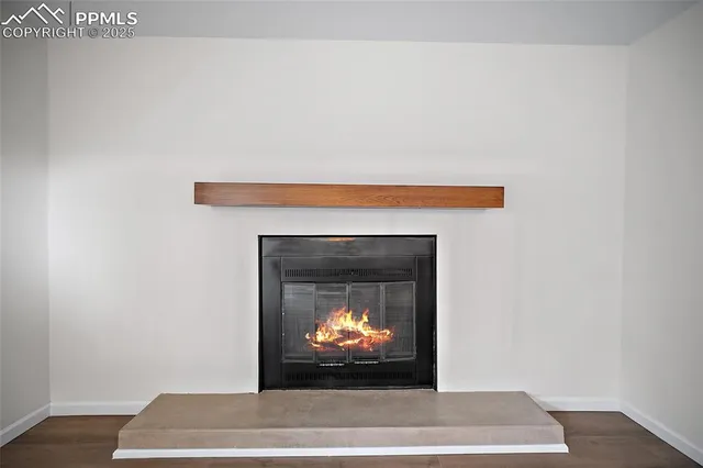 a living room with a fireplace and a wooden floor