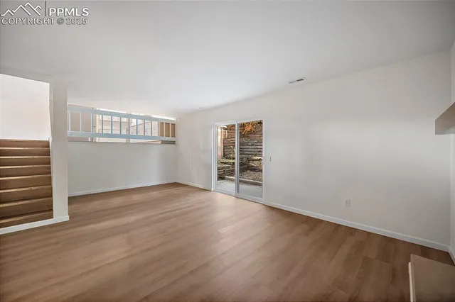 a view of wooden floor and windows in a room