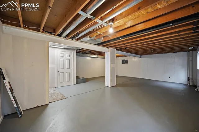 a view of empty room with white walls