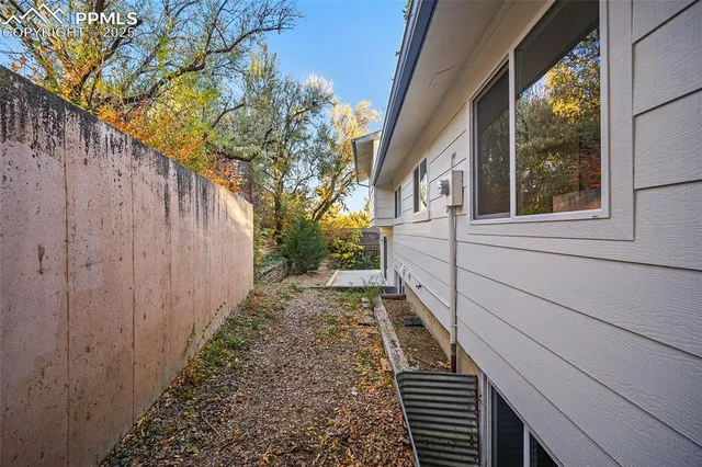 a view of a pathway of a house with wooden fence and floor