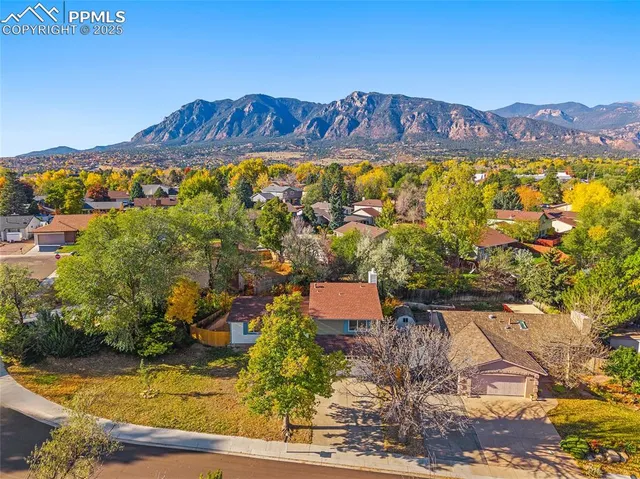an aerial view of a house with a yard