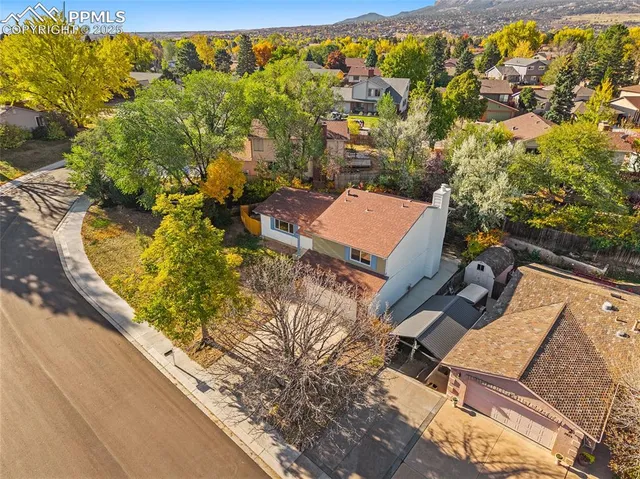 an aerial view of a house with a yard and lake view