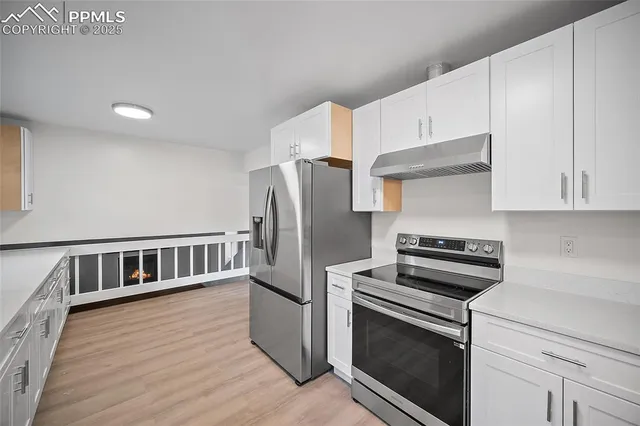 a kitchen with stainless steel appliances a refrigerator stove and microwave