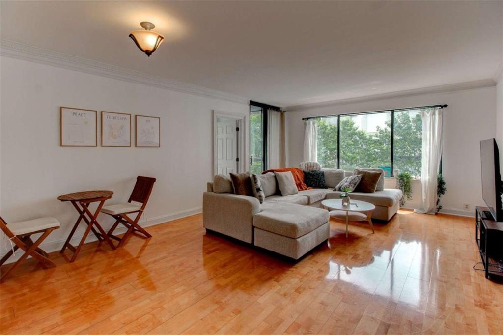 3481 Lakeside Drive Northeast, Unit 902 Atlanta, GA 30326 - Photo 1 of 43 a living room with furniture and a large window