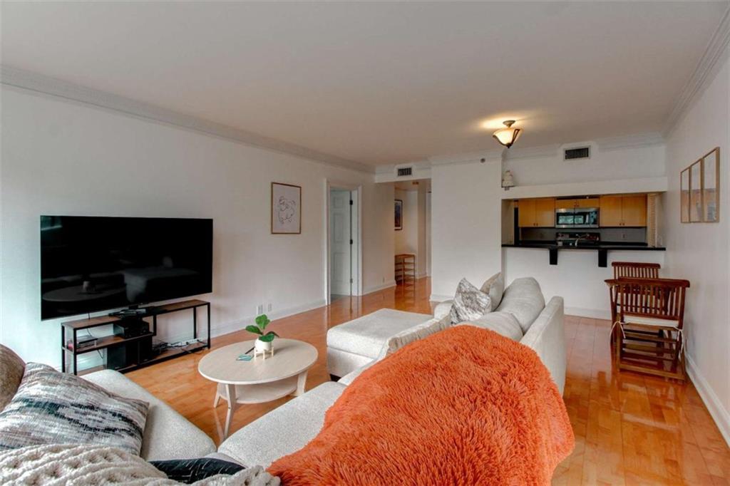 3481 Lakeside Drive Northeast, Unit 902 Atlanta, GA 30326 - Photo 11 of 43 a bedroom with furniture and a flat screen tv