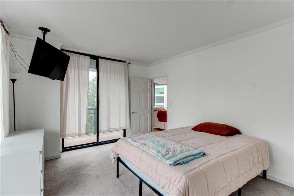 3481 Lakeside Drive Northeast, Unit 902 Atlanta, GA 30326 - Photo 16 of 43 a bedroom with a bed and a flat screen tv
