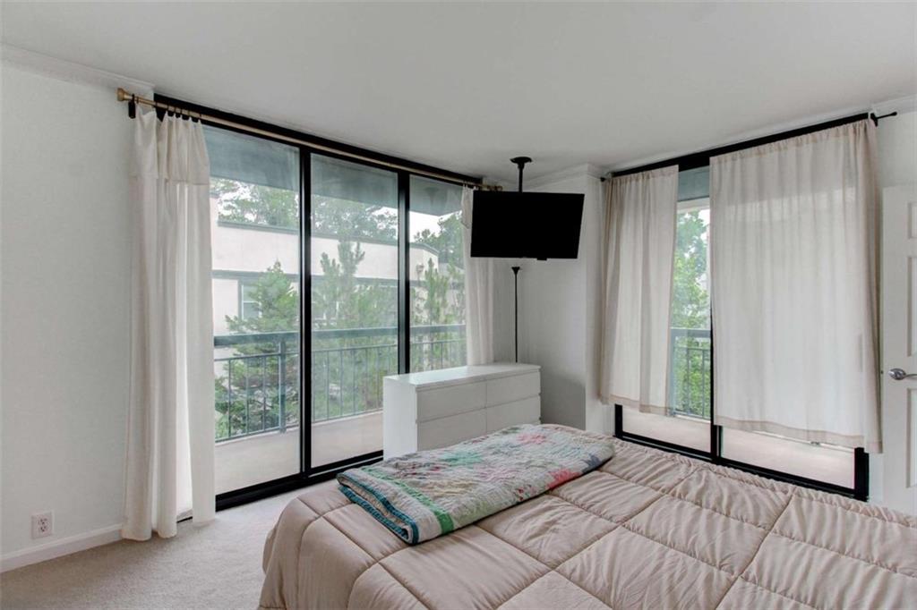 3481 Lakeside Drive Northeast, Unit 902 Atlanta, GA 30326 - Photo 17 of 43 a bedroom with a large bed and a large window
