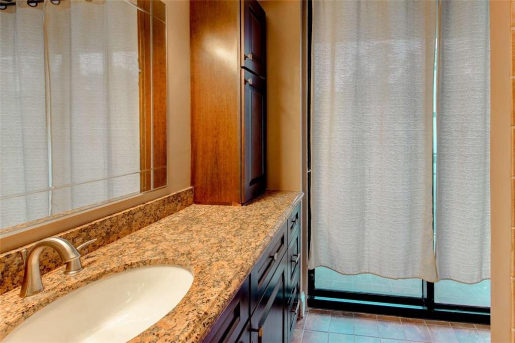 3481 Lakeside Drive Northeast, Unit 902 Atlanta, GA 30326 - Photo 21 of 43 a bathroom with a granite countertop sink and a mirror