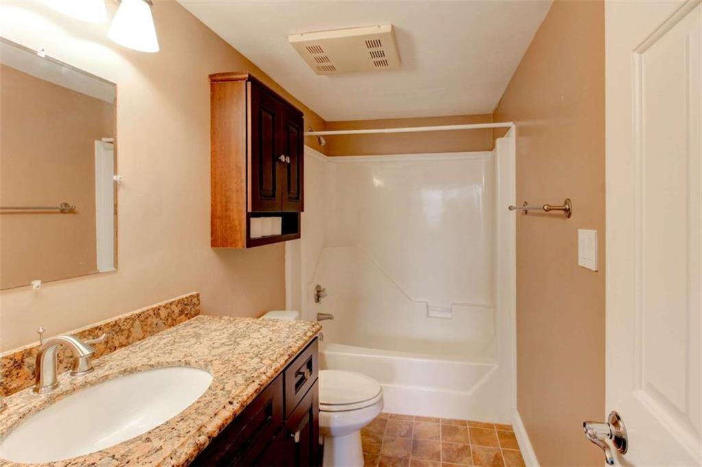 3481 Lakeside Drive Northeast, Unit 902 Atlanta, GA 30326 - Photo 27 of 43 a bathroom with a granite countertop sink toilet and shower