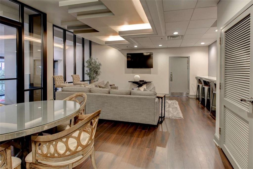 3481 Lakeside Drive Northeast, Unit 902 Atlanta, GA 30326 - Photo 30 of 43 a living room with furniture and a flat screen tv