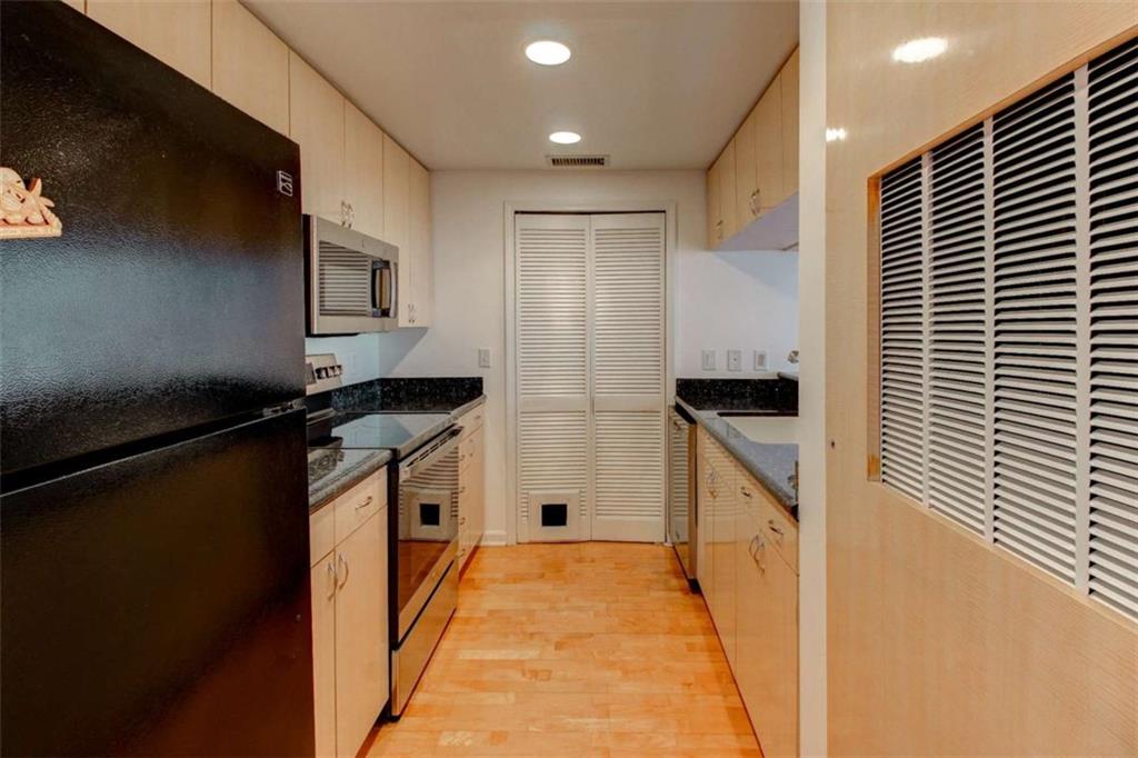 3481 Lakeside Drive Northeast, Unit 902 Atlanta, GA 30326 - Photo 3 of 43 a kitchen with a refrigerator and a stove