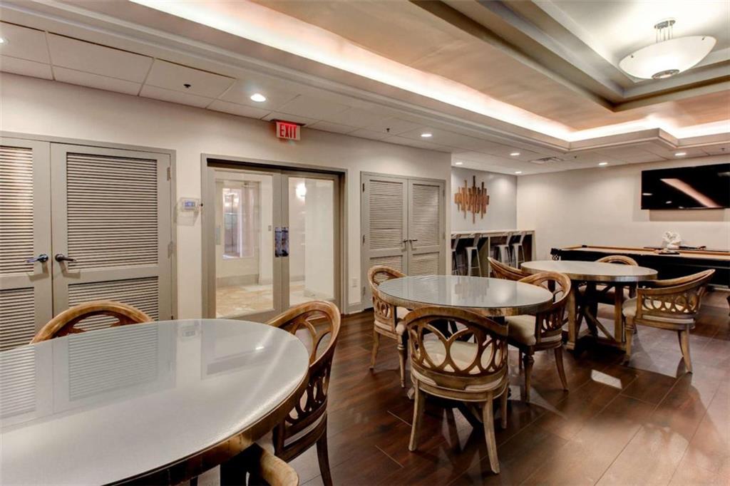 3481 Lakeside Drive Northeast, Unit 902 Atlanta, GA 30326 - Photo 31 of 43 a kitchen with a table chairs and a dining table