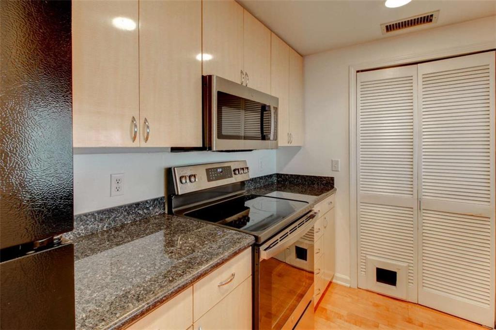 3481 Lakeside Drive Northeast, Unit 902 Atlanta, GA 30326 - Photo 5 of 43 a kitchen that has a sink and a stove