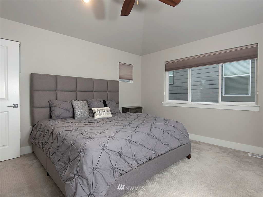 17 197th Place Southwest Bothell, WA 98012 - Photo 21 of 34 a bedroom with a bed a dresser and windows