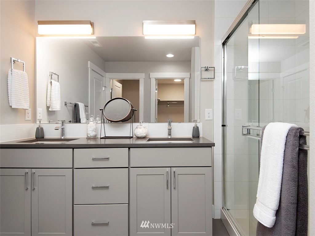 17 197th Place Southwest Bothell, WA 98012 - Photo 24 of 34 a bathroom with a granite countertop sink and a mirror
