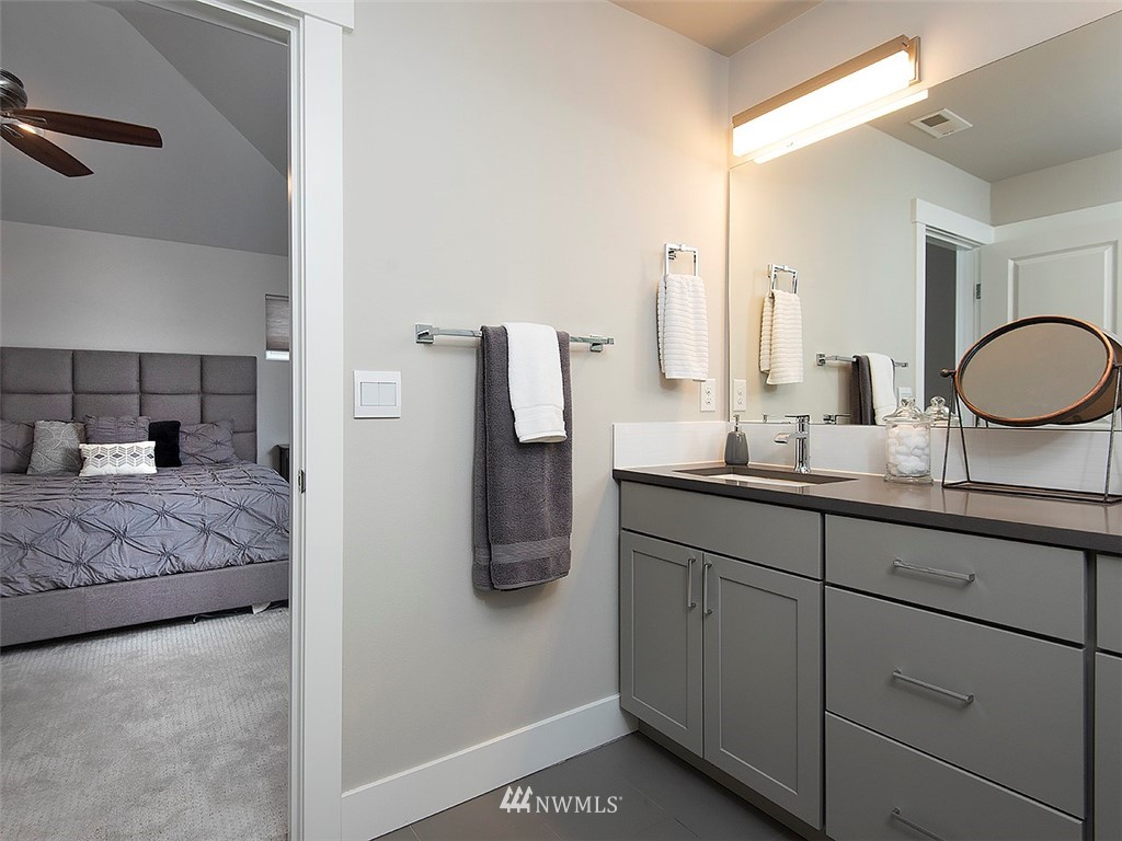 17 197th Place Southwest Bothell, WA 98012 - Photo 25 of 34 a en suite bathroom with a granite countertop sink and a mirror