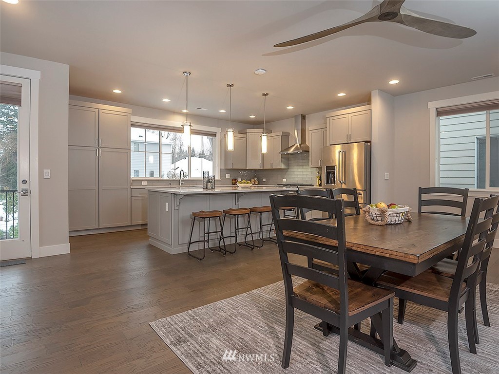 17 197th Place Southwest Bothell, WA 98012 - Photo 3 of 34 a kitchen with a dining table chairs and refrigerator