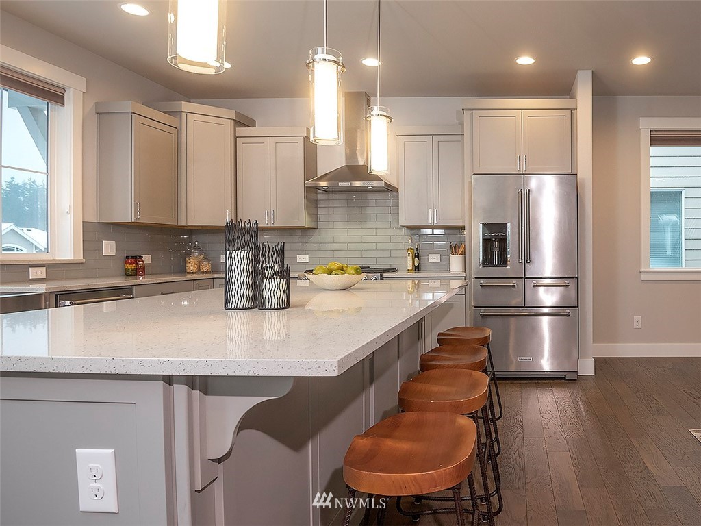 17 197th Place Southwest Bothell, WA 98012 - Photo 4 of 34 a kitchen with stainless steel appliances granite countertop a sink refrigerator and microwave